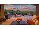 Serene patio with grill, comfortable seating, desert landscaping, and sunset sky at 41731 N Rolling Green Way, Anthem, AZ 85086