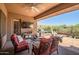 Cozy outdoor patio with grill, lounge chairs, desert landscaping, and clear blue sky at 41731 N Rolling Green Way, Anthem, AZ 85086