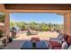 Expansive covered patio with desert views, grill, lounge chairs, and flagstone at 41731 N Rolling Green Way, Anthem, AZ 85086