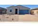 Charming single-story home featuring a blue garage door, low-maintenance landscaping, and brick paver driveway at 4211 W Lisa Ln, San Tan Valley, AZ 85144
