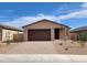 Charming single-story home featuring a well-maintained front yard and a two-car garage at 4212 W Lisa Ln, San Tan Valley, AZ 85144