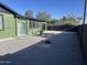 A backyard featuring a gravel area, a patio, and a charming green home exterior creates an inviting outdoor space at 4602 N 47Th N Ave, Phoenix, AZ 85031