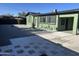 A backyard with a tiled patio, gravel landscaping, and a green exterior creates a low-maintenance outdoor retreat at 4602 N 47Th N Ave, Phoenix, AZ 85031