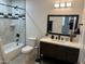 Beautiful bathroom featuring stylish vanity with dark fixtures and decorative tiled shower-tub combination at 4602 N 47Th N Ave, Phoenix, AZ 85031