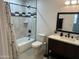 Updated bathroom features modern fixtures, stylish vanity, and tiled shower-tub combination at 4602 N 47Th N Ave, Phoenix, AZ 85031