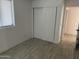 A clean and empty bedroom featuring light-colored flooring and a closet at 4602 N 47Th N Ave, Phoenix, AZ 85031