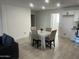 Bright dining area with a modern table, neutral chairs, and elegant lighting, seamlessly connected to the kitchen and living spaces at 4602 N 47Th N Ave, Phoenix, AZ 85031