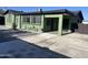 A well-maintained green house showcasing a covered patio, fresh exterior paint, and an inviting outdoor area at 4602 N 47Th N Ave, Phoenix, AZ 85031