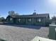 A bright single-story home features an expansive gravel yard, complementing its green exterior and dark gray shingle roof at 4602 N 47Th N Ave, Phoenix, AZ 85031
