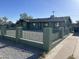 Charming single-story home with green paint, black trim, and a gravel yard, enhanced by a dark gray shingle roof at 4602 N 47Th N Ave, Phoenix, AZ 85031