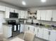 Bright kitchen featuring white cabinets, granite countertops and stainless steel appliances, eat-in table at 4602 N 47Th N Ave, Phoenix, AZ 85031