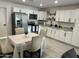 Bright kitchen with white cabinets, stainless steel appliances, granite countertops, and dining table at 4602 N 47Th N Ave, Phoenix, AZ 85031
