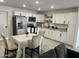 Bright kitchen with white cabinets, stainless steel appliances, granite countertops, and dining table at 4602 N 47Th N Ave, Phoenix, AZ 85031