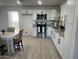 Modern kitchen featuring white cabinetry, stainless steel appliances, granite countertops, and stylish fixtures, ideal for cooking and dining at 4602 N 47Th N Ave, Phoenix, AZ 85031