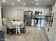 Well-lit kitchen featuring white cabinets, stainless steel appliances, granite countertops, and a dining table at 4602 N 47Th N Ave, Phoenix, AZ 85031
