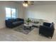 Modern living area with comfortable seating, neutral decor, and a spacious layout, enhanced by stylish flooring and abundant natural light at 4602 N 47Th N Ave, Phoenix, AZ 85031