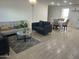 Open-concept living and dining area featuring stylish furniture, modern flooring, and abundant natural light, blending comfort with style at 4602 N 47Th N Ave, Phoenix, AZ 85031