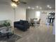 Spacious living area with tile floors, modern furniture, and an open layout that connects seamlessly to the dining and kitchen spaces at 4602 N 47Th N Ave, Phoenix, AZ 85031