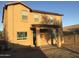 The back exterior of the house features a covered patio and a large yard perfect for outdoor activities at 4722 S 238Th Ln, Buckeye, AZ 85326