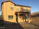 A back exterior showing the covered patio and large yard at 4722 S 238Th Ln, Buckeye, AZ 85326