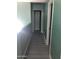 Hallway with neutral paint, leading to various rooms in the home at 4722 S 238Th Ln, Buckeye, AZ 85326