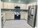 A kitchen with white cabinetry, stainless steel appliances, granite countertops, and new hardwood floors at 4722 S 238Th Ln, Buckeye, AZ 85326