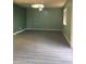 Spacious living room with modern light fixture and light-colored wood flooring at 4722 S 238Th Ln, Buckeye, AZ 85326