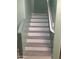 Interior stairs with wood-look steps, white risers, and modern railing design at 4722 S 238Th Ln, Buckeye, AZ 85326