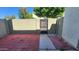 Private patio with red concrete pavers, block fencing, and a metal gate at 4752 W Palo Verde Dr, Glendale, AZ 85301