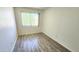 A bright bedroom with neutral paint, laminate flooring and a view to the outside at 4752 W Palo Verde Dr, Glendale, AZ 85301