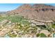 Aerial view showcasing a lush golf course community with stunning mountain views and luxurious homes at 4849 N Camelback Ridge Rd # B403, Scottsdale, AZ 85251