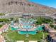 Stunning aerial view of resort pools, lush landscaping, and surrounding mountain landscape at 4849 N Camelback Ridge Rd # B403, Scottsdale, AZ 85251