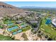 Expansive aerial view of the property highlighting tennis courts, lush golf courses, and a scenic mountain backdrop at 4849 N Camelback Ridge Rd # B403, Scottsdale, AZ 85251