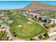 Beautiful aerial view of a golf course and modern homes set against a backdrop of rugged mountains at 4849 N Camelback Ridge Rd # B403, Scottsdale, AZ 85251