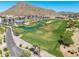 Aerial view of a pristine golf course featuring manicured greens and picturesque mountain views at 4849 N Camelback Ridge Rd # B403, Scottsdale, AZ 85251