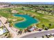 Aerial view showcasing the lush green golf course with a scenic lake and landscaped surroundings at 4849 N Camelback Ridge Rd # B403, Scottsdale, AZ 85251
