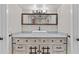 Bathroom features a rustic-style vanity, granite countertop, an ornate mirror, and modern fixtures at 5525 E Thomas Rd # K16, Phoenix, AZ 85018