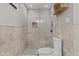 Bathroom showcases tiled shower with pebble flooring, toilet, decorative nook and shower head at 5525 E Thomas Rd # K16, Phoenix, AZ 85018