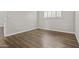 Vacant bedroom with wood floors, white trim, and a window offering natural light at 5525 E Thomas Rd # K16, Phoenix, AZ 85018