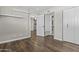 An empty bedroom offering wood floors, white trim, an open doorway, and ample closet space at 5525 E Thomas Rd # K16, Phoenix, AZ 85018