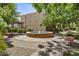 A tranquil courtyard fountain surrounded by lush greenery and seating for residents to enjoy at 5525 E Thomas Rd # K16, Phoenix, AZ 85018