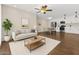 Open living room features a modern design with wood floors, and a view of the kitchen and dining area at 5525 E Thomas Rd # K16, Phoenix, AZ 85018