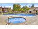 Community swimming pool and hot tub with comfortable lounge chairs and well-manicured landscaping at 5525 E Thomas Rd # K16, Phoenix, AZ 85018