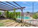 Relaxing backyard area with lush greenery and a shaded pergola, ideal for outdoor entertaining at 5615 W Camelback Rd, Phoenix, AZ 85031