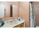 Functional bathroom featuring a single vanity, ample counter space, and a shower with a patterned curtain at 5615 W Camelback Rd, Phoenix, AZ 85031