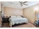 Spacious bedroom featuring a ceiling fan and neutral-toned brick walls, creating a cozy atmosphere at 5615 W Camelback Rd, Phoenix, AZ 85031