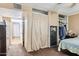 Bedroom featuring a hidden gun safe, and access to storage and closet space behind beige curtains at 5615 W Camelback Rd, Phoenix, AZ 85031