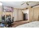 Comfortable bedroom with a workspace featuring a wall-mounted TV, offering relaxation and productivity at 5615 W Camelback Rd, Phoenix, AZ 85031
