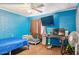 Bright bedroom with blue walls, featuring a comfortable bed, study area, and a fun, playful atmosphere at 5615 W Camelback Rd, Phoenix, AZ 85031