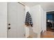 Clean entryway with a white door and coat rack, leading to a cozy interior with tile flooring at 5615 W Camelback Rd, Phoenix, AZ 85031